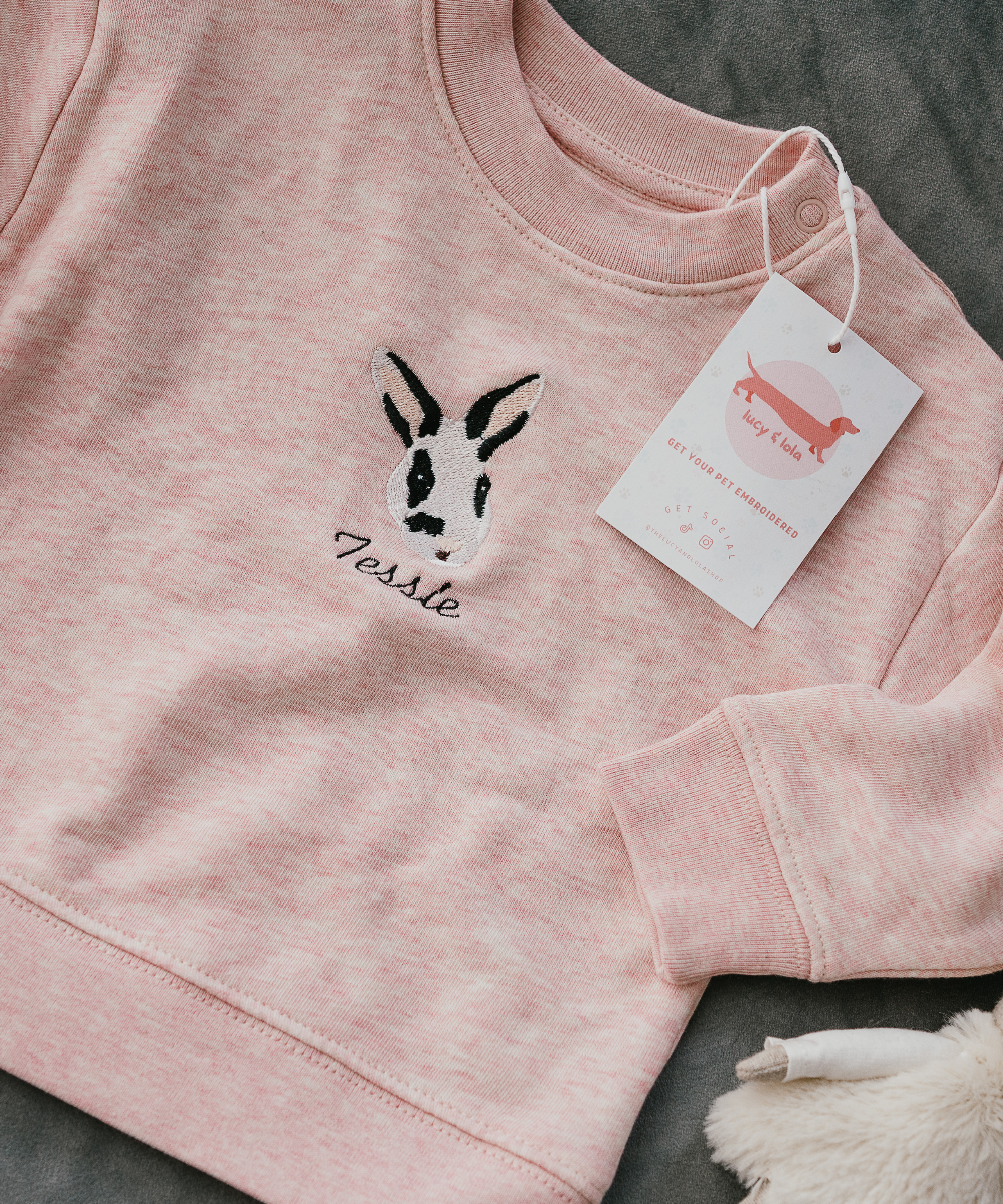 Custom embroidered sweatshirt featuring a hand-drawn pet portrait on organic cotton fabric.