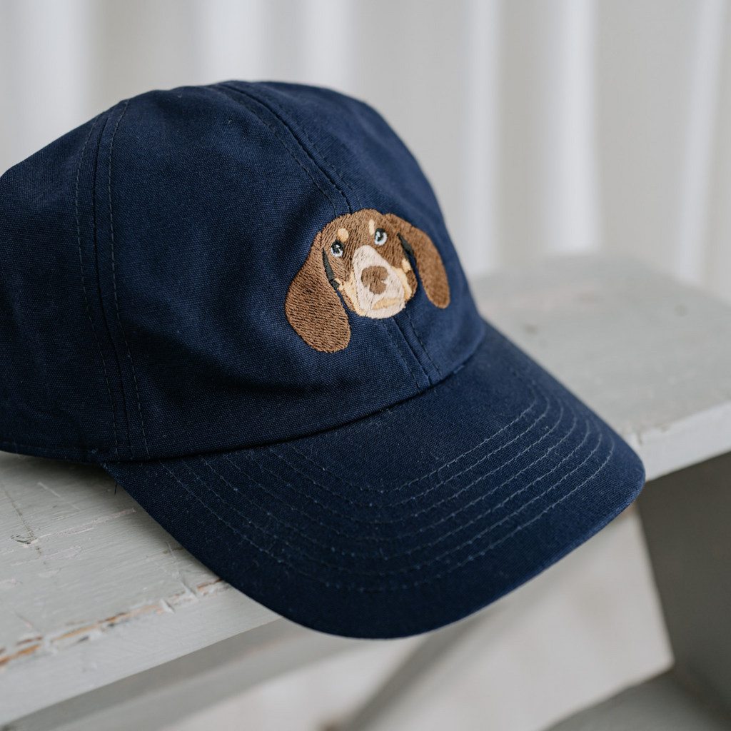a custom embroidered baseball cap featuring a hand-drawn pet portrait, the perfect personalised pet gift