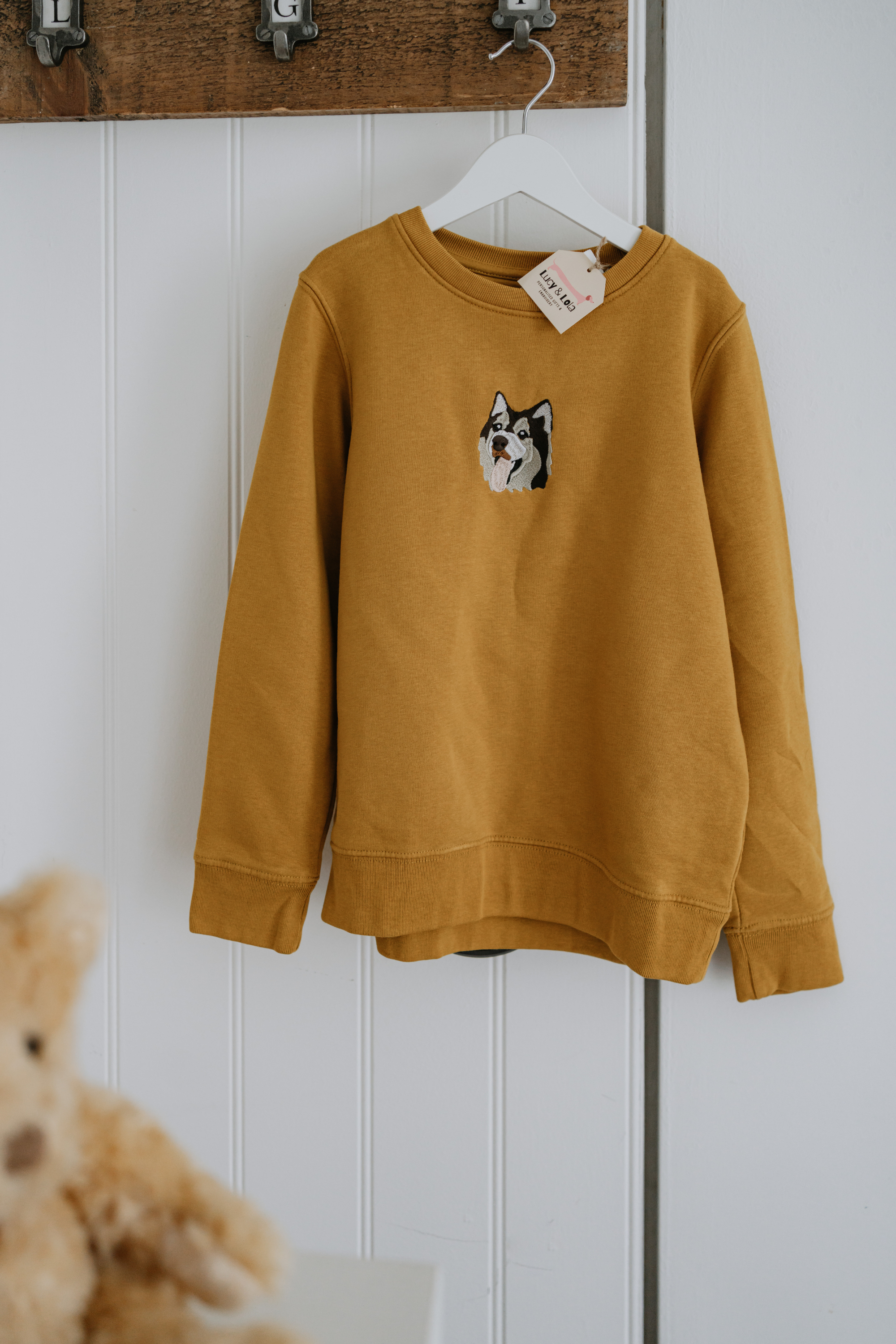 a custom embroidered hoodie featuring a hand-drawn pet portrait, the perfect personalised pet gift.