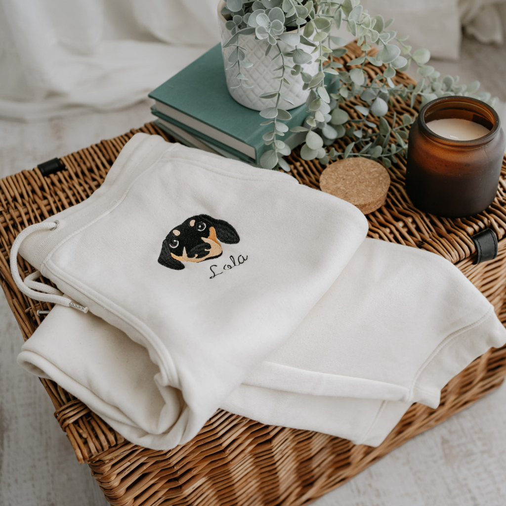 a custom embroidered organic cotton tracksuit bottoms featuring a hand-drawn pet portrait, the perfect personalised pet gift for a dog mum