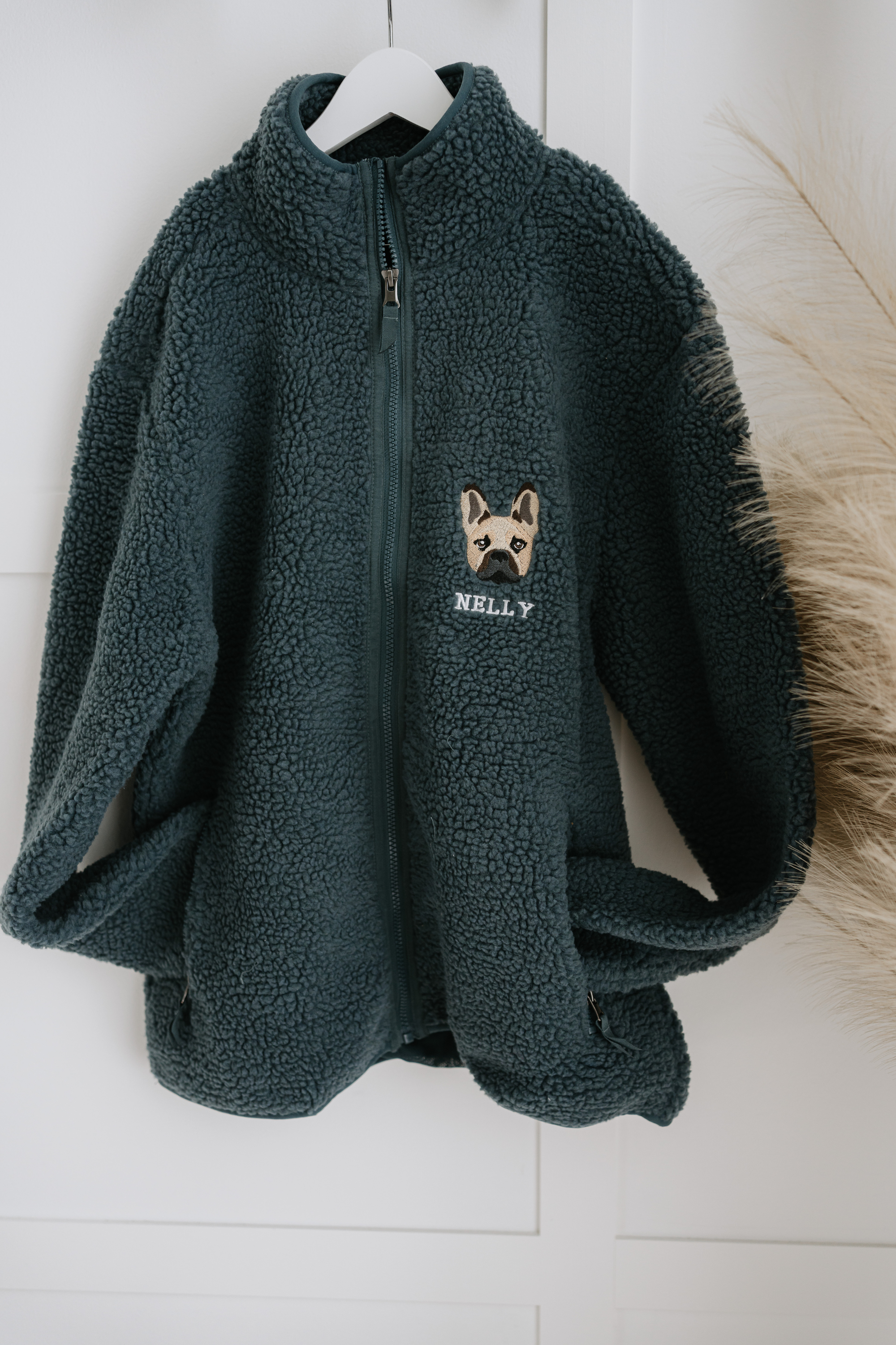 a custom embroidered dog walker sherpa jacket featuring a hand-drawn pet portrait, the perfect personalised pet gift for a dog mum