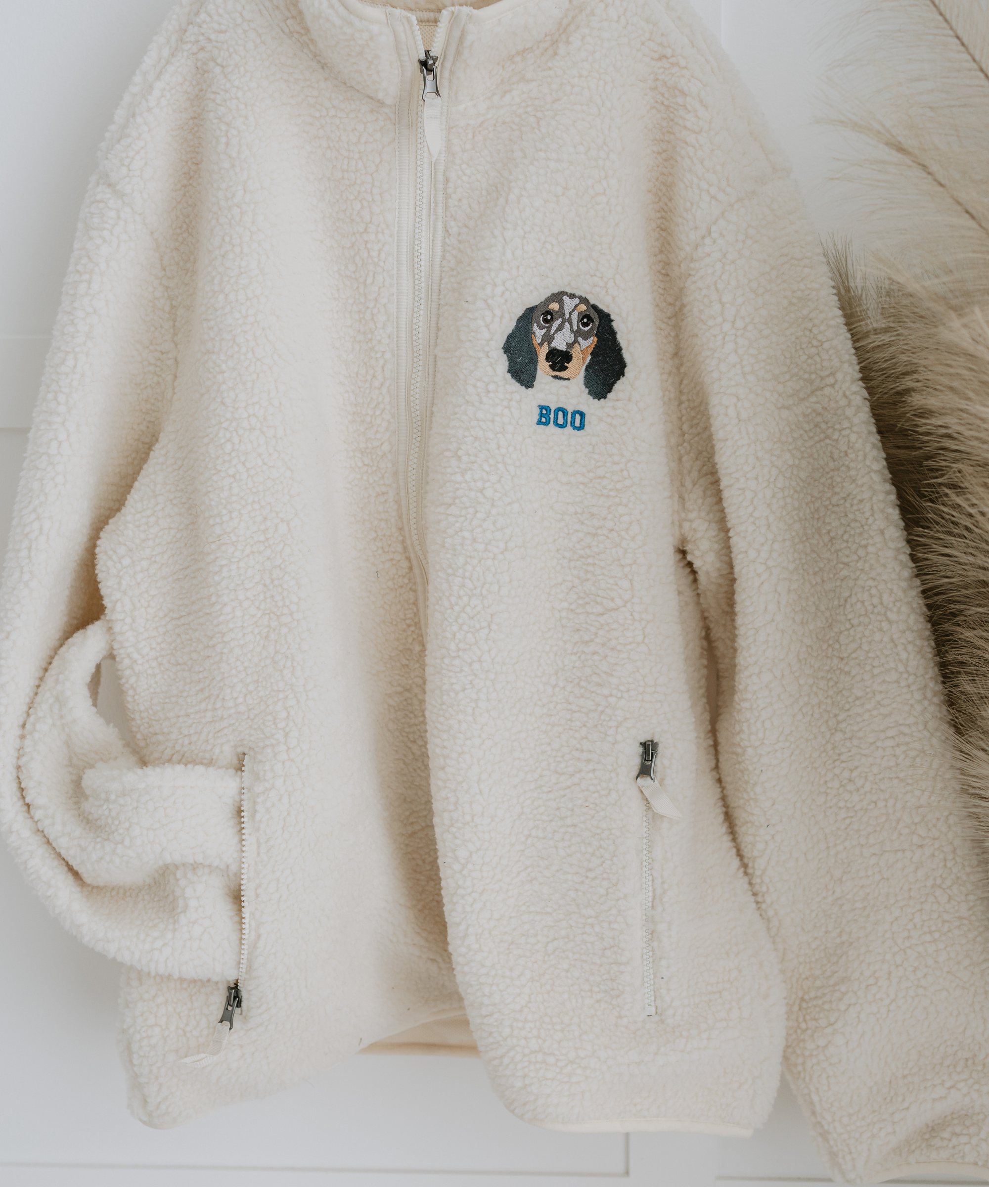 a custom embroidered dog walker sherpa jacket featuring a hand-drawn pet portrait, the perfect personalised pet gift for a dog mum
